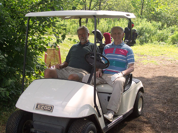 golfers on golf cart