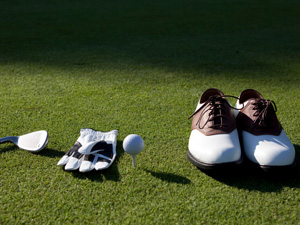 golf accessories lined up on the grass